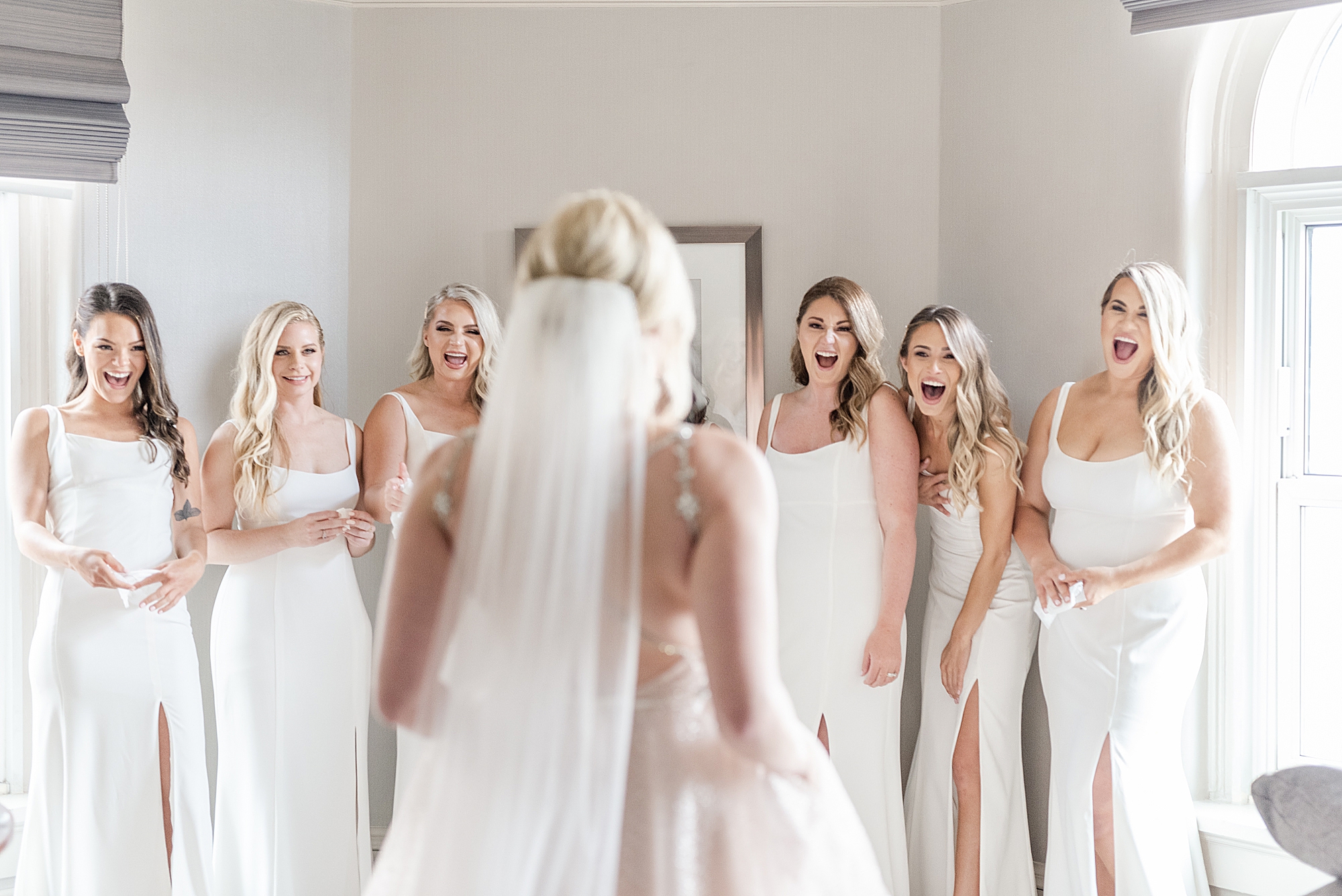 bridesmaids react to seeing bride in wedding dress