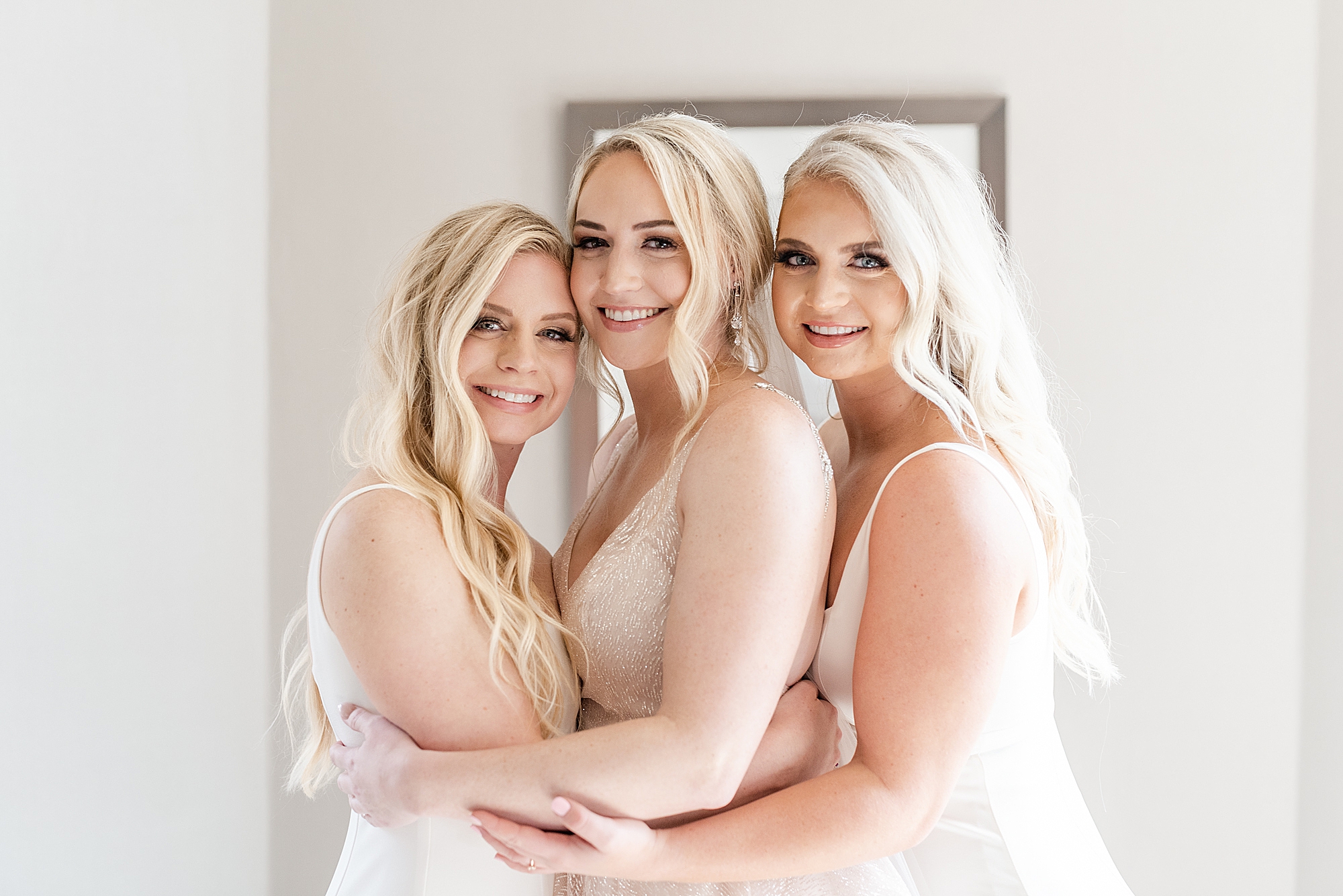 bride hugs sisters in Columbus OH hotel