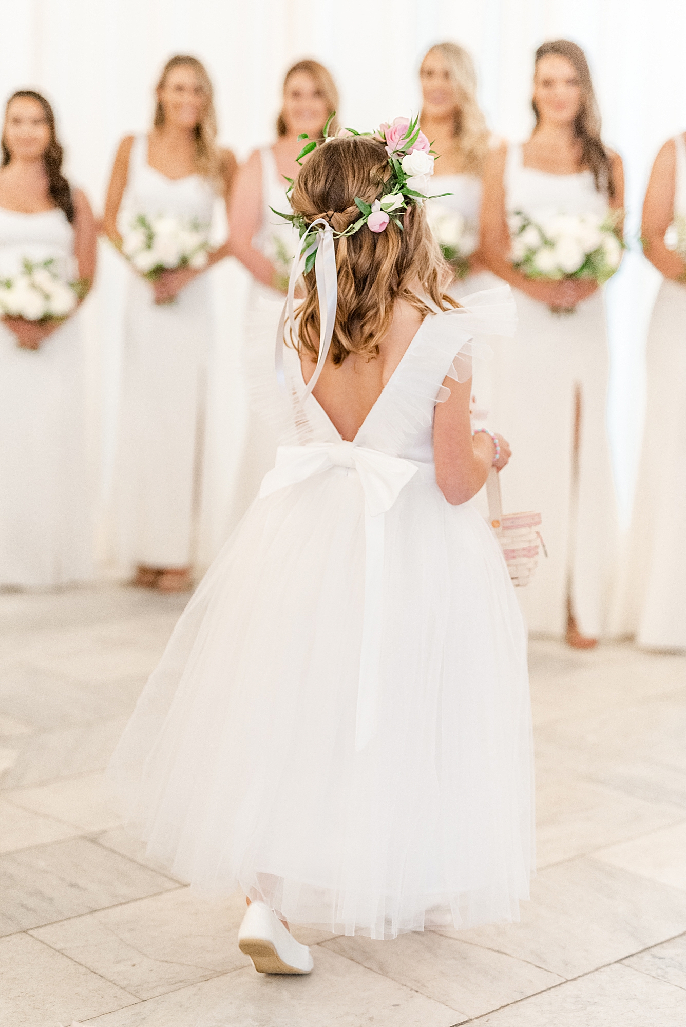 flower girl walks down aisle during Westin Southern Columbus wedding ceremony for stylish couple
