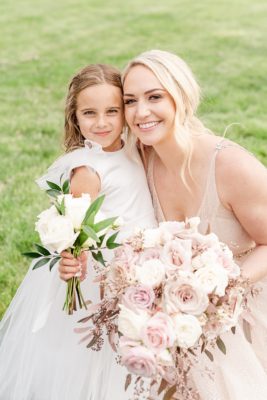 bride hugs flower girl during Westin Southern Columbus wedding photos