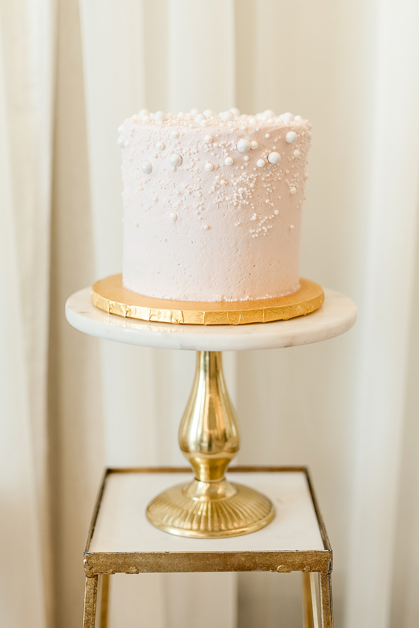 simple wedding cake with pink and gold details