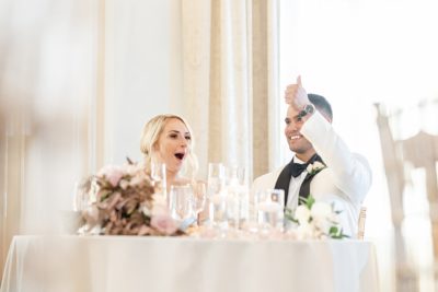 groom gives thumbs up during wedding toast