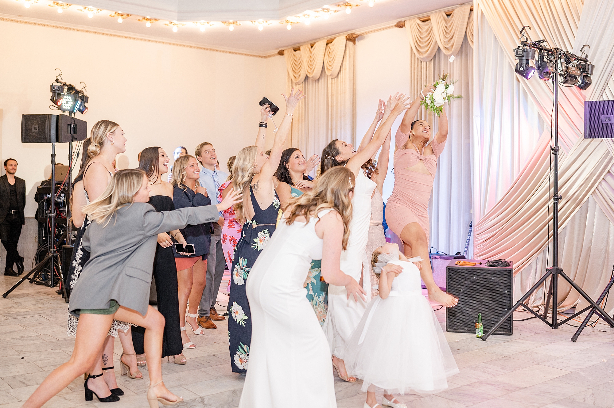 bride tosses bouquet for bridesmaids