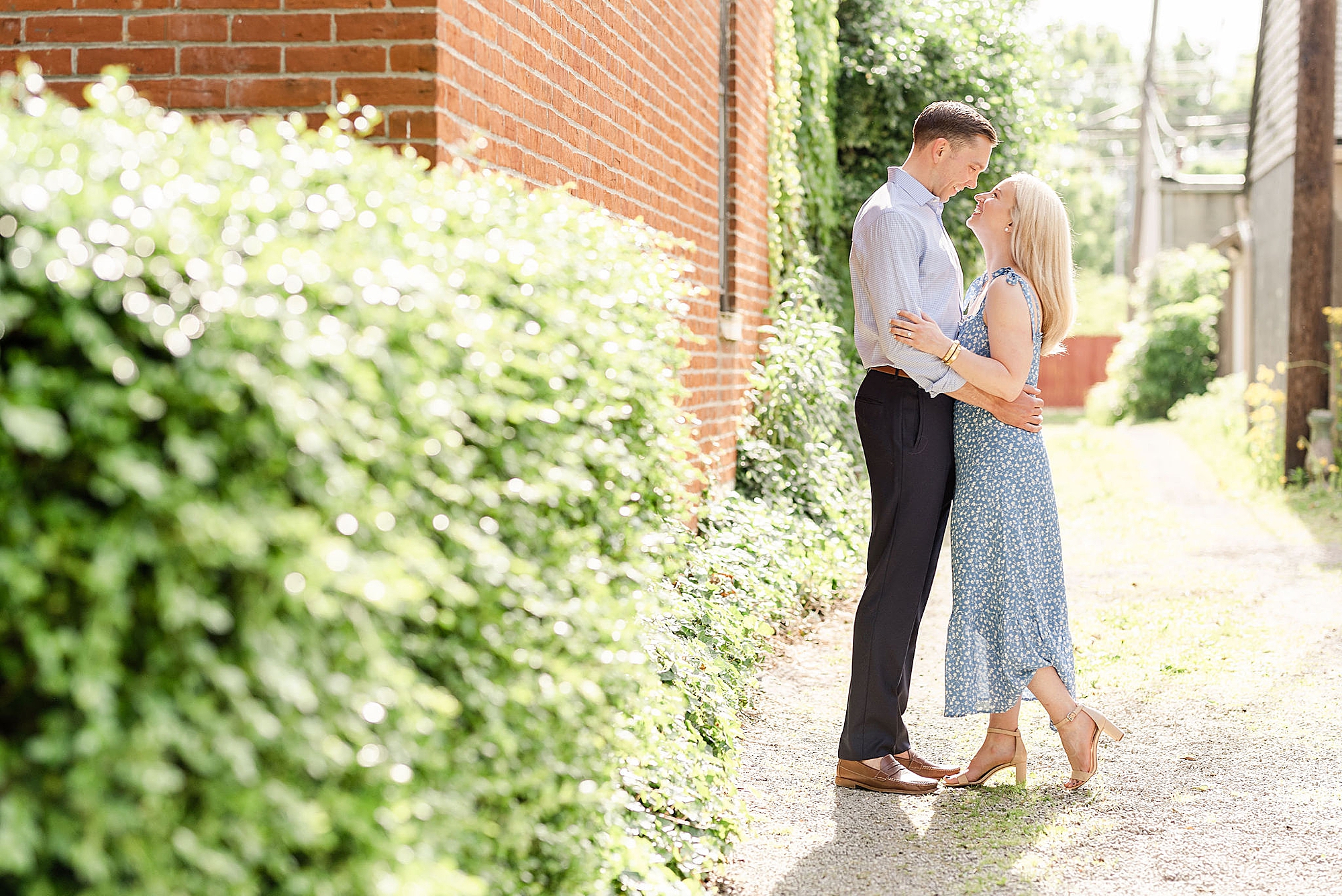 downtown Columbus engagement session with couple by brick wall