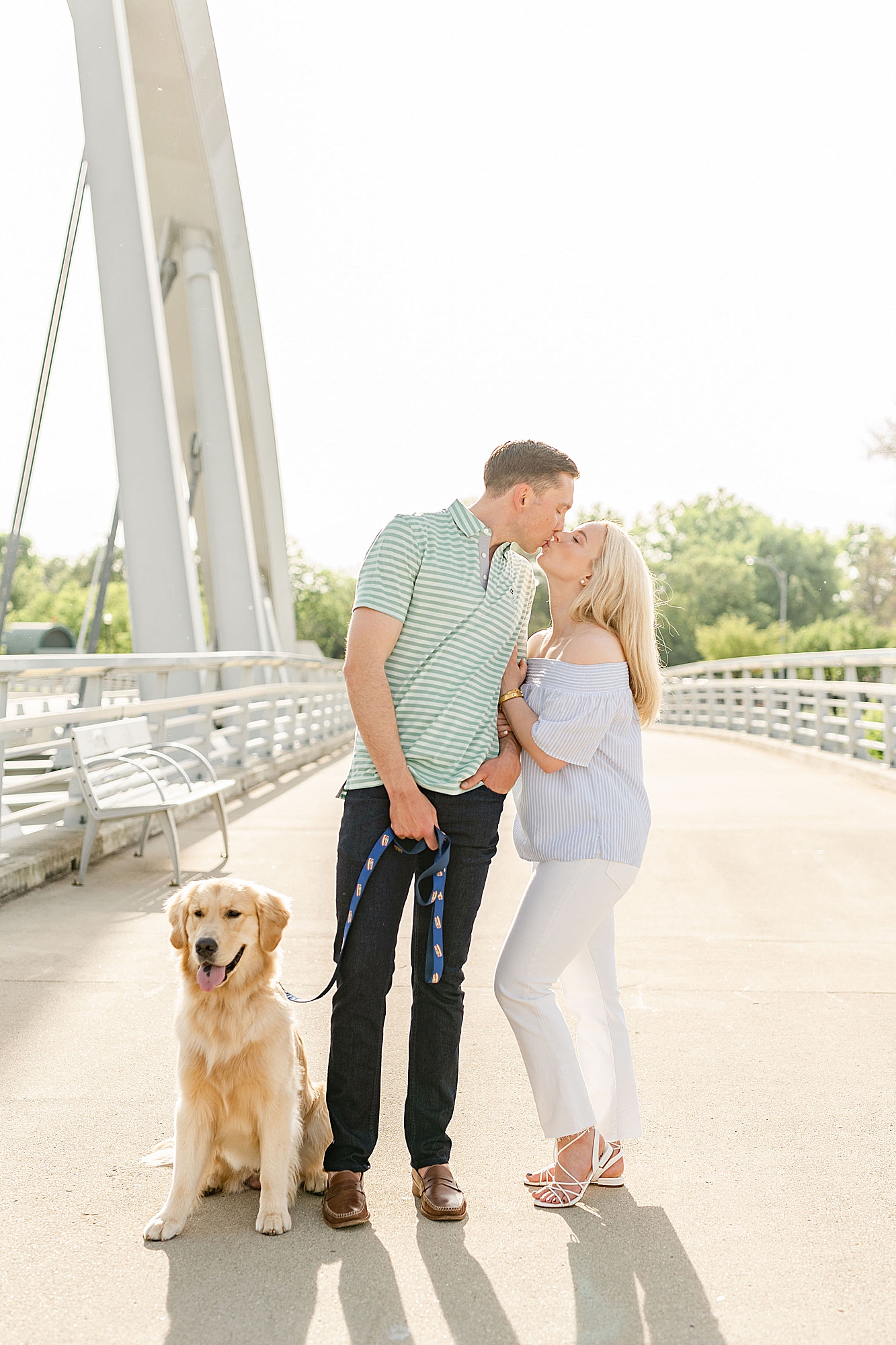 couple kisses on bridge during Ohio engagement photos