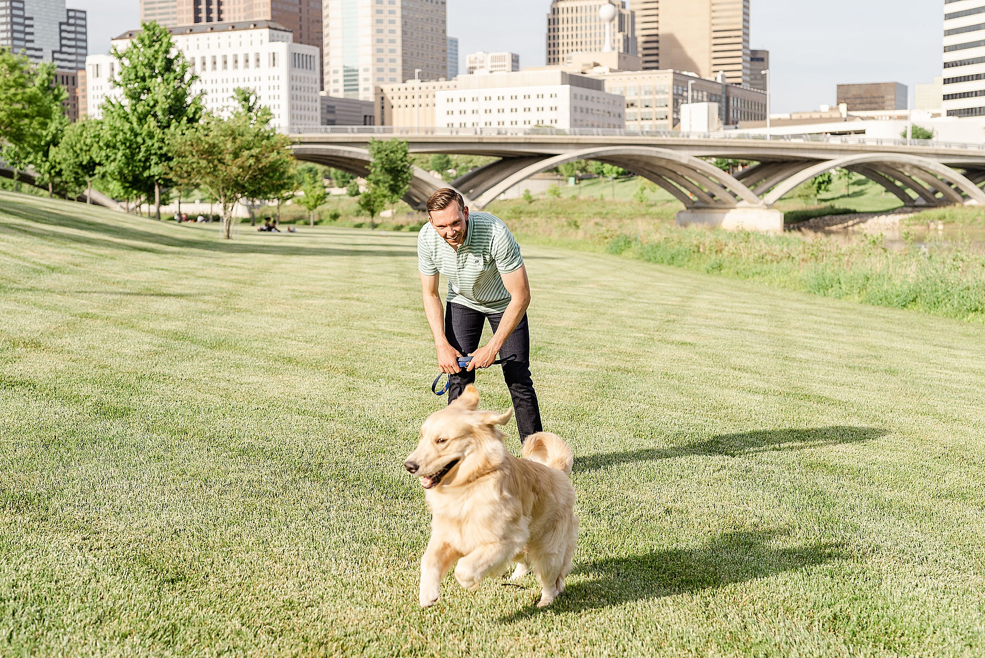 groom chases golden retriever during Ohio engagement session
