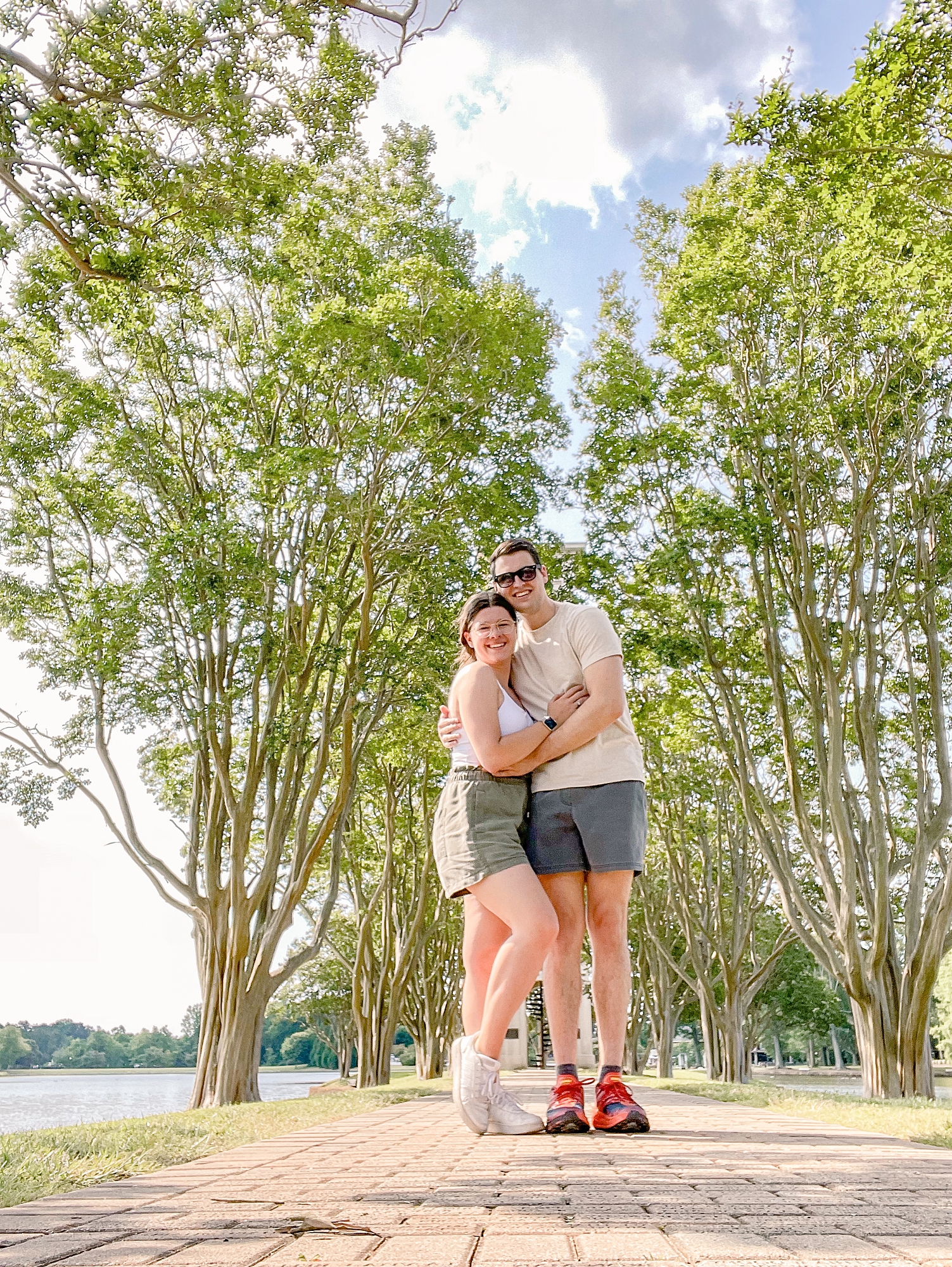married couple hugs together in park