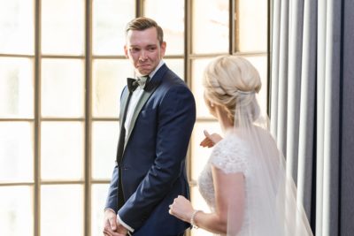 groom turns to see bride during first look at the Athletic Club of Columbus