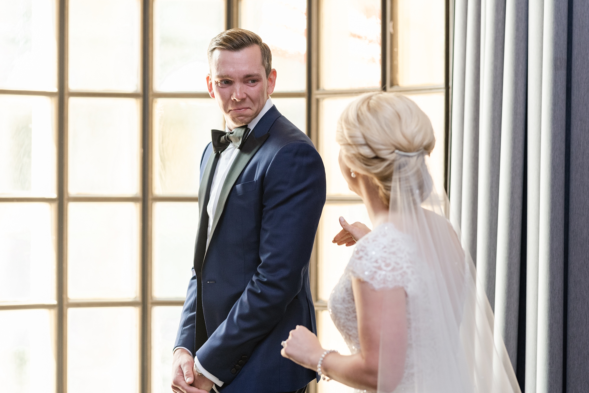 groom turns to see bride during first look at the Athletic Club of Columbus