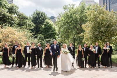 newlyweds walk with wedding party in Columbus OH