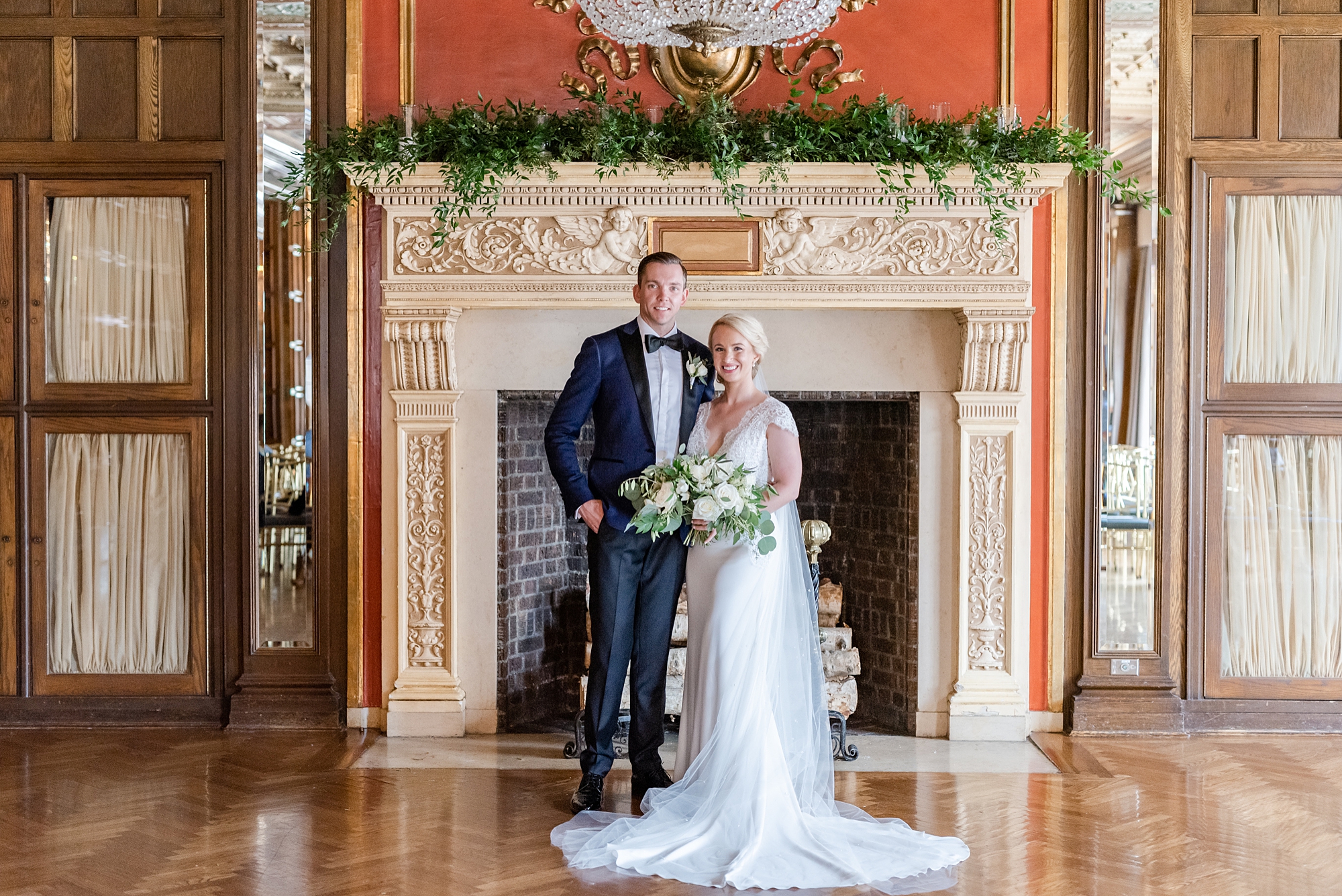 newlyweds pose along fireplace at the Athletic Club of Columbus