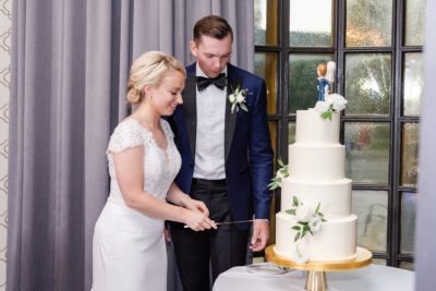 bride cuts wedding cake with groom during Columbus OH wedding reception