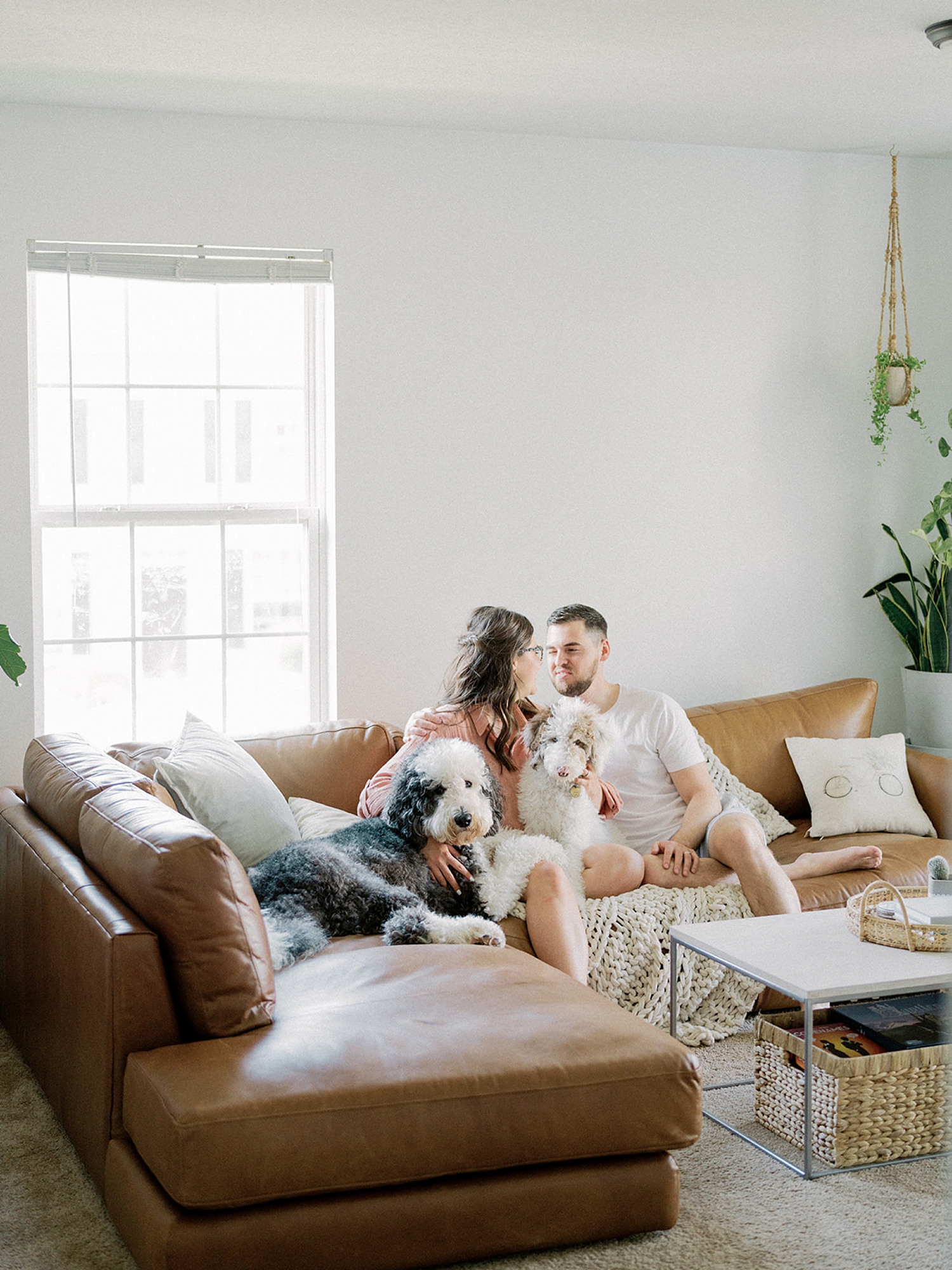 fourth anniversary portraits at home for young couple and two dogs