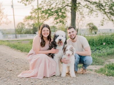 couple poses at Old Slate Farm with two dogs