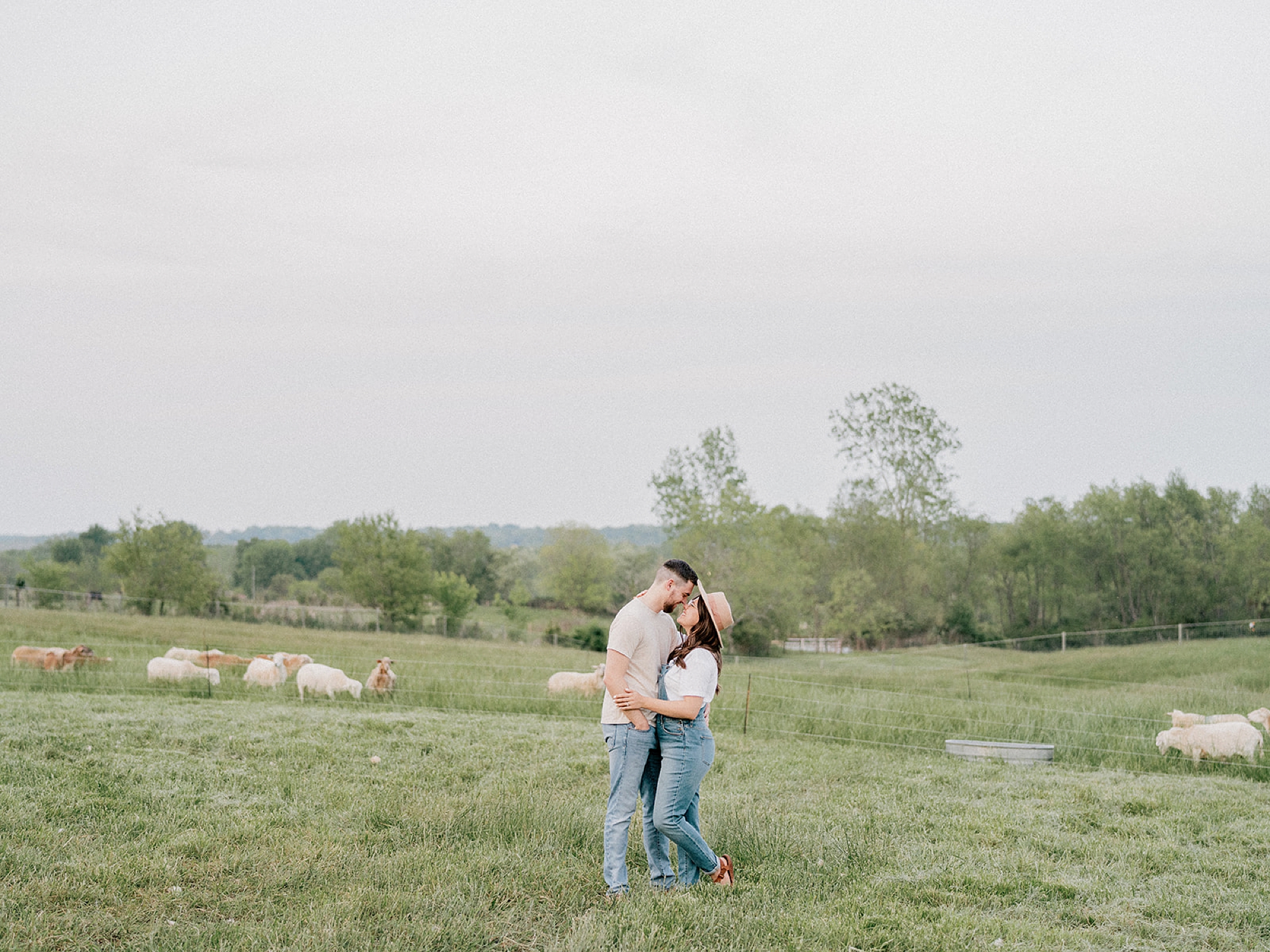 married couple hugs in field during Ohio anniversary photos