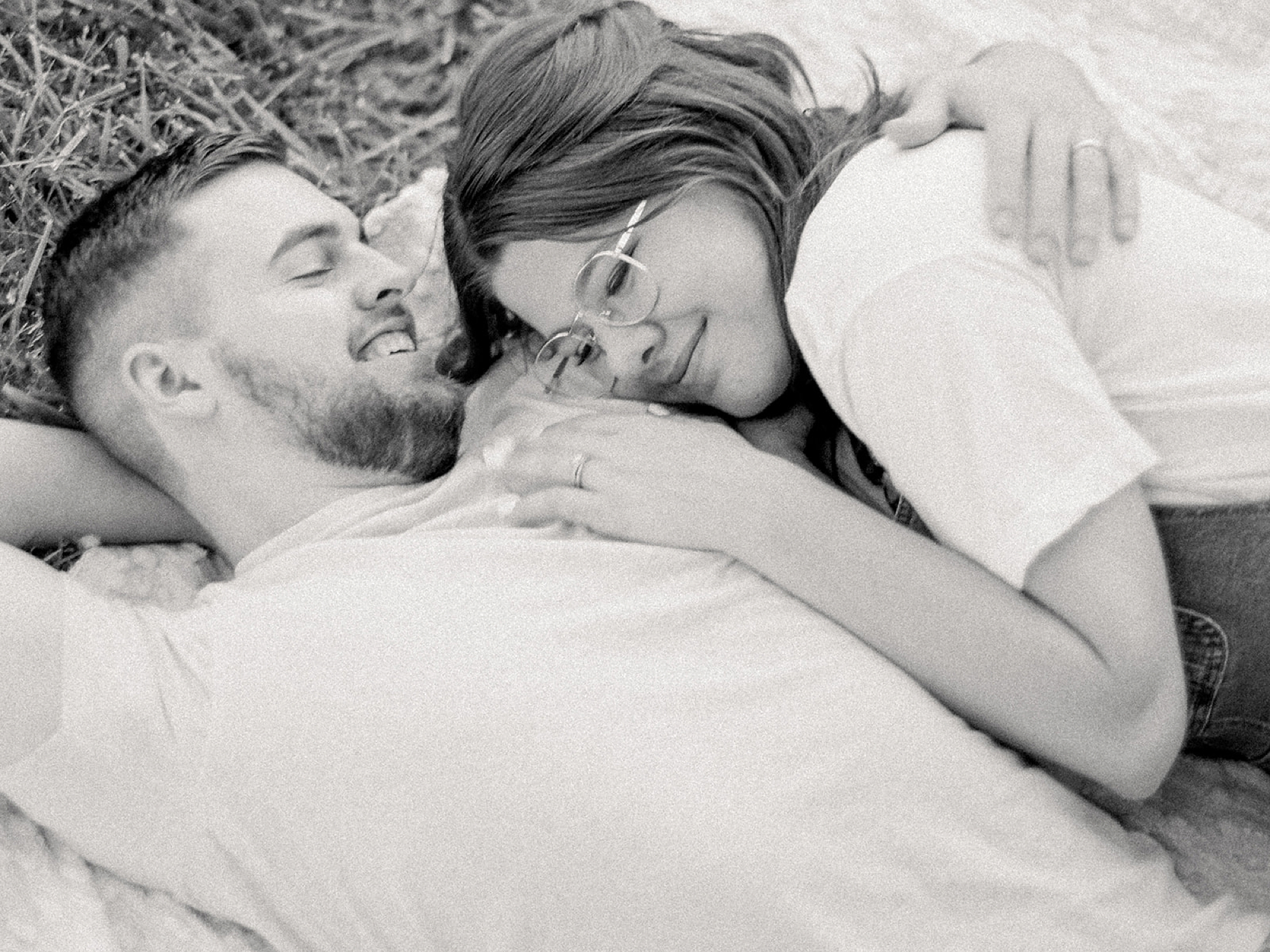 wife lays on husband's chest during fourth anniversary portraits