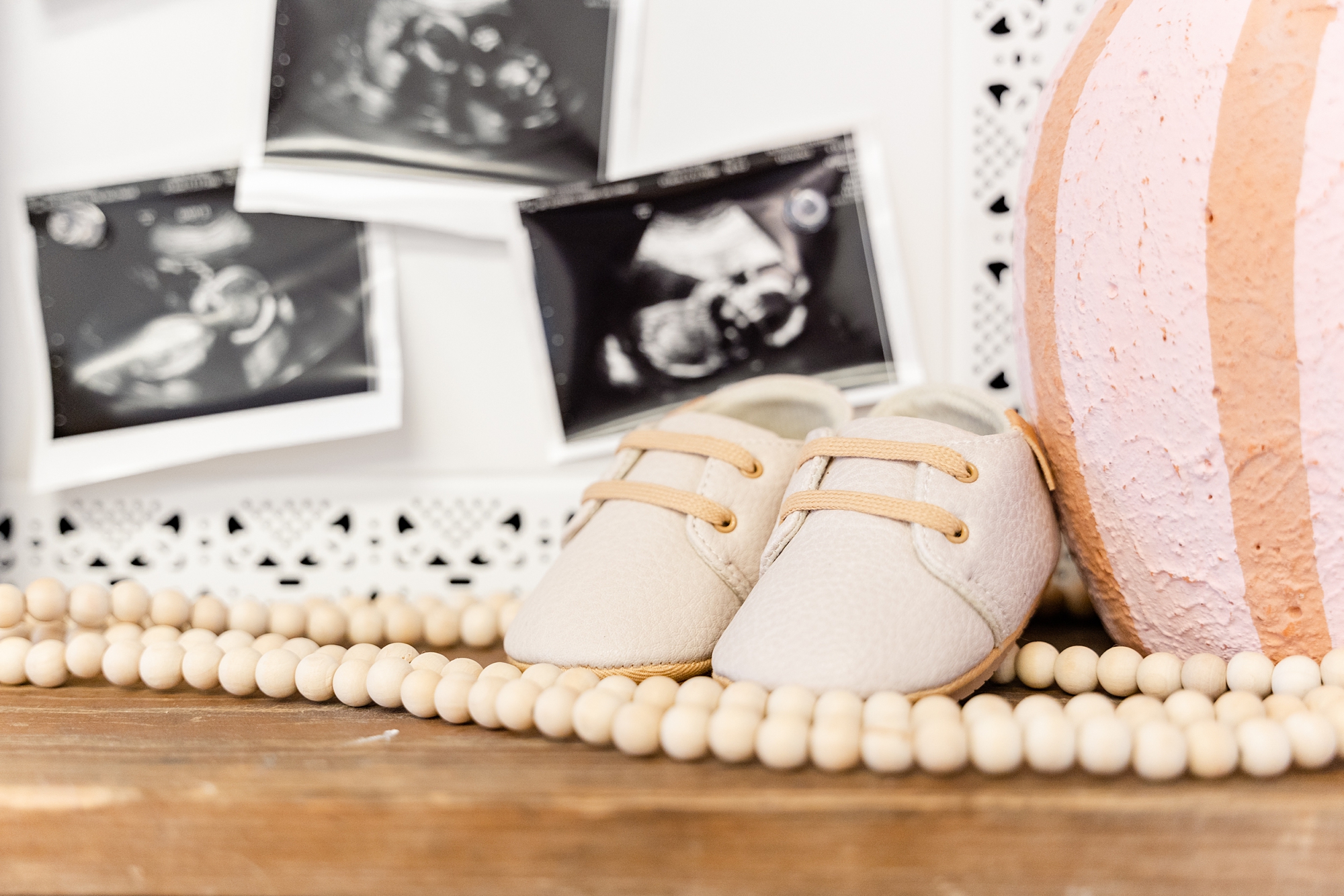 baby shoes sit by sonogram photos for twins