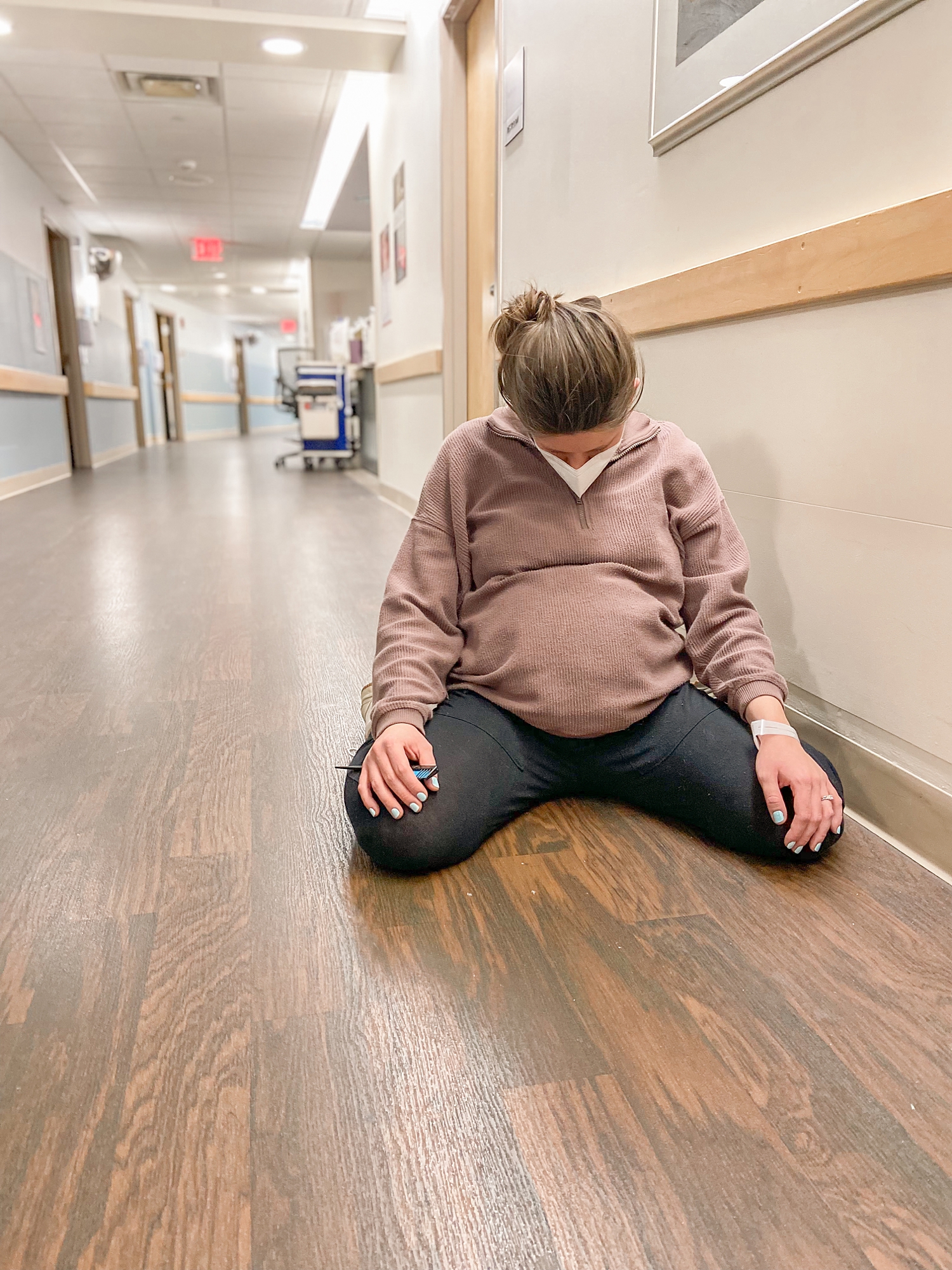 woman sits on floor during contraction