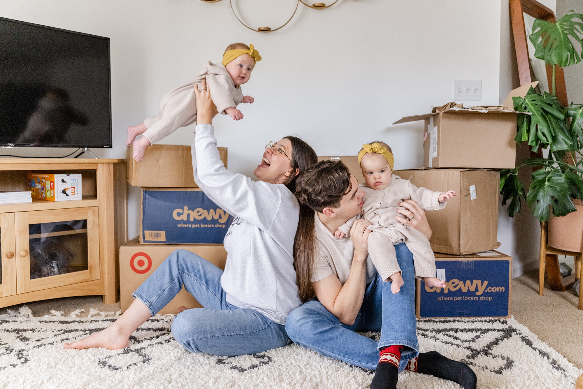 parents play with babies by moving boxes
